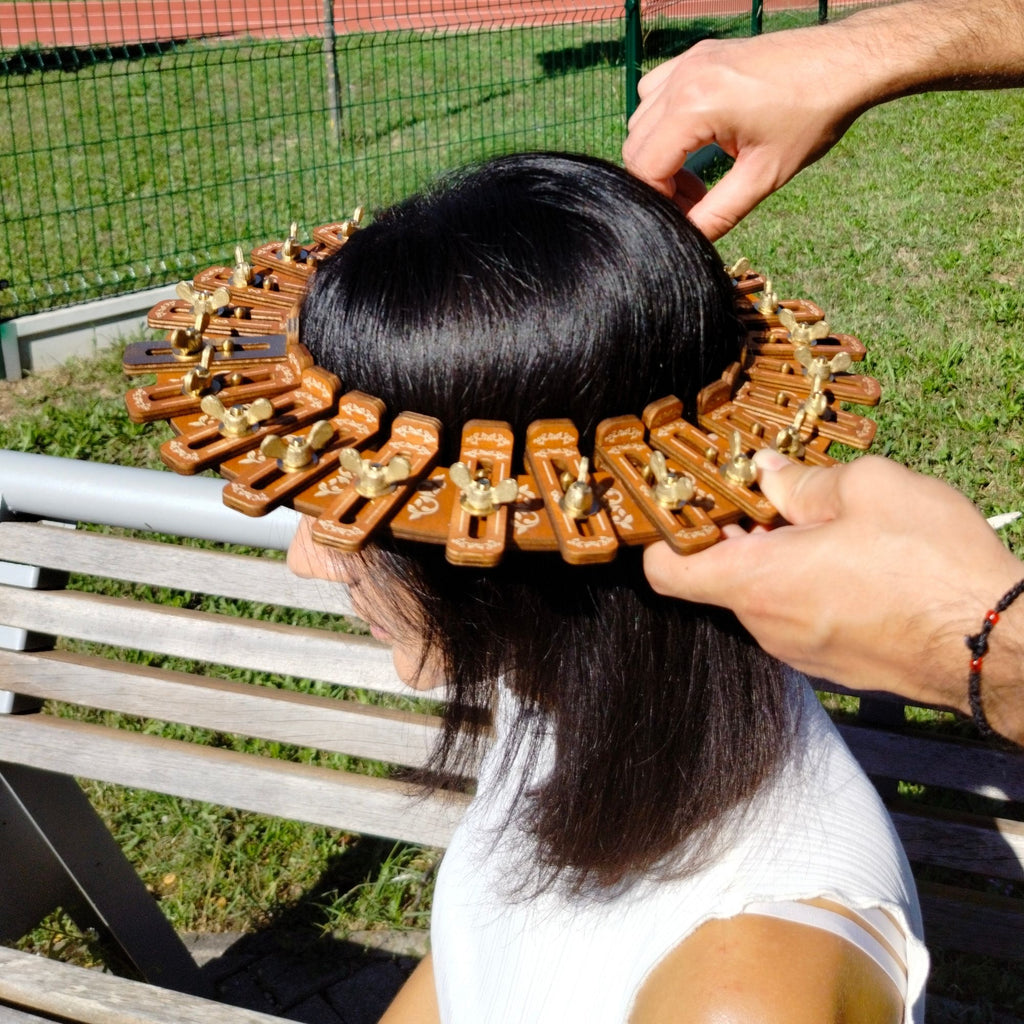 Hat conformer being used to measure head size outdoors