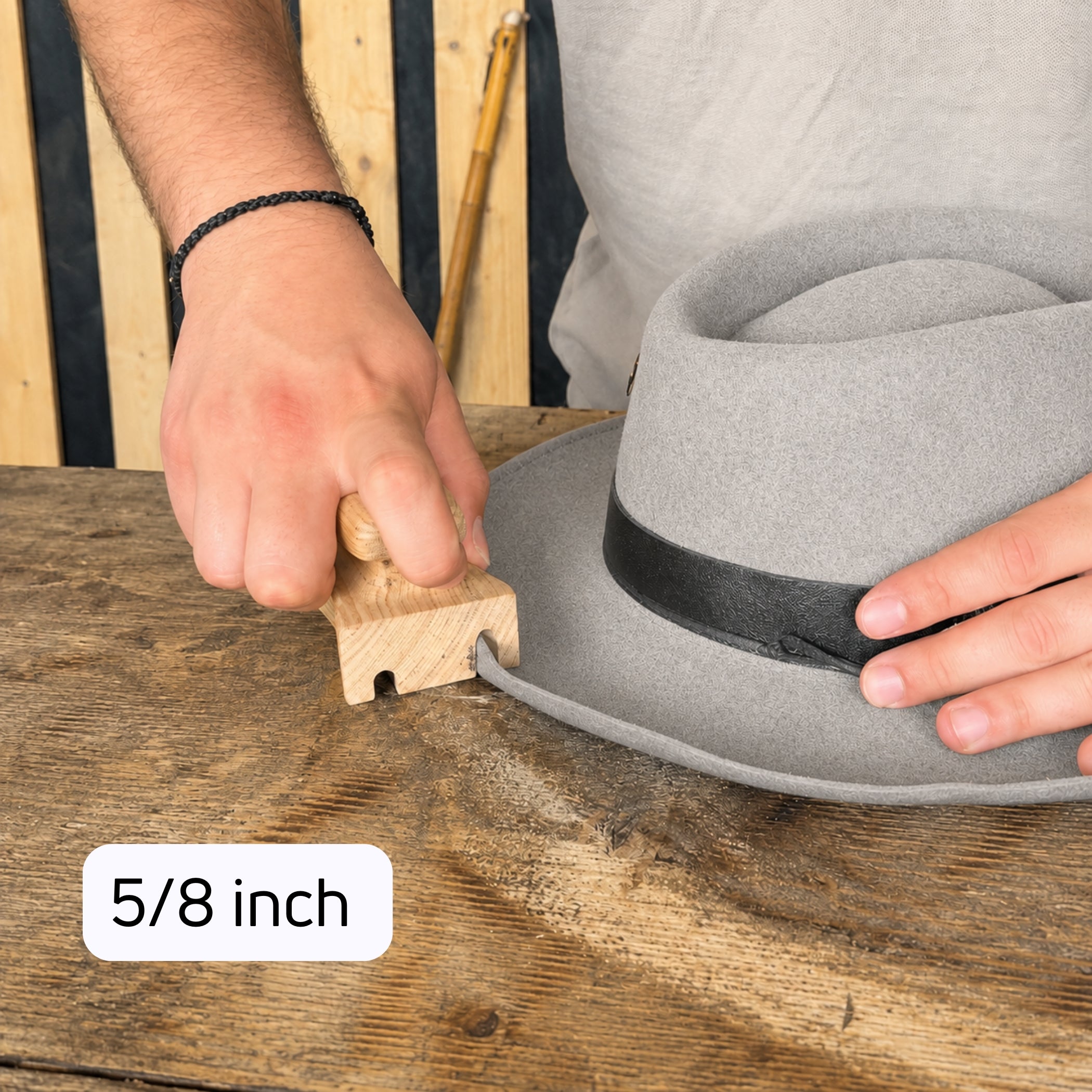 5/8 inch wooden brim curler shaping a rolled edge on a gray felt hat