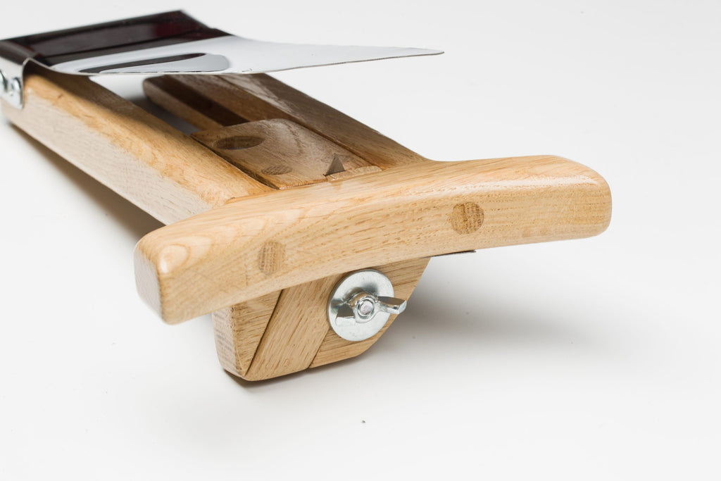 Close-up of wooden hat brim cutter handle and blade assembly for precise felt brim cutting