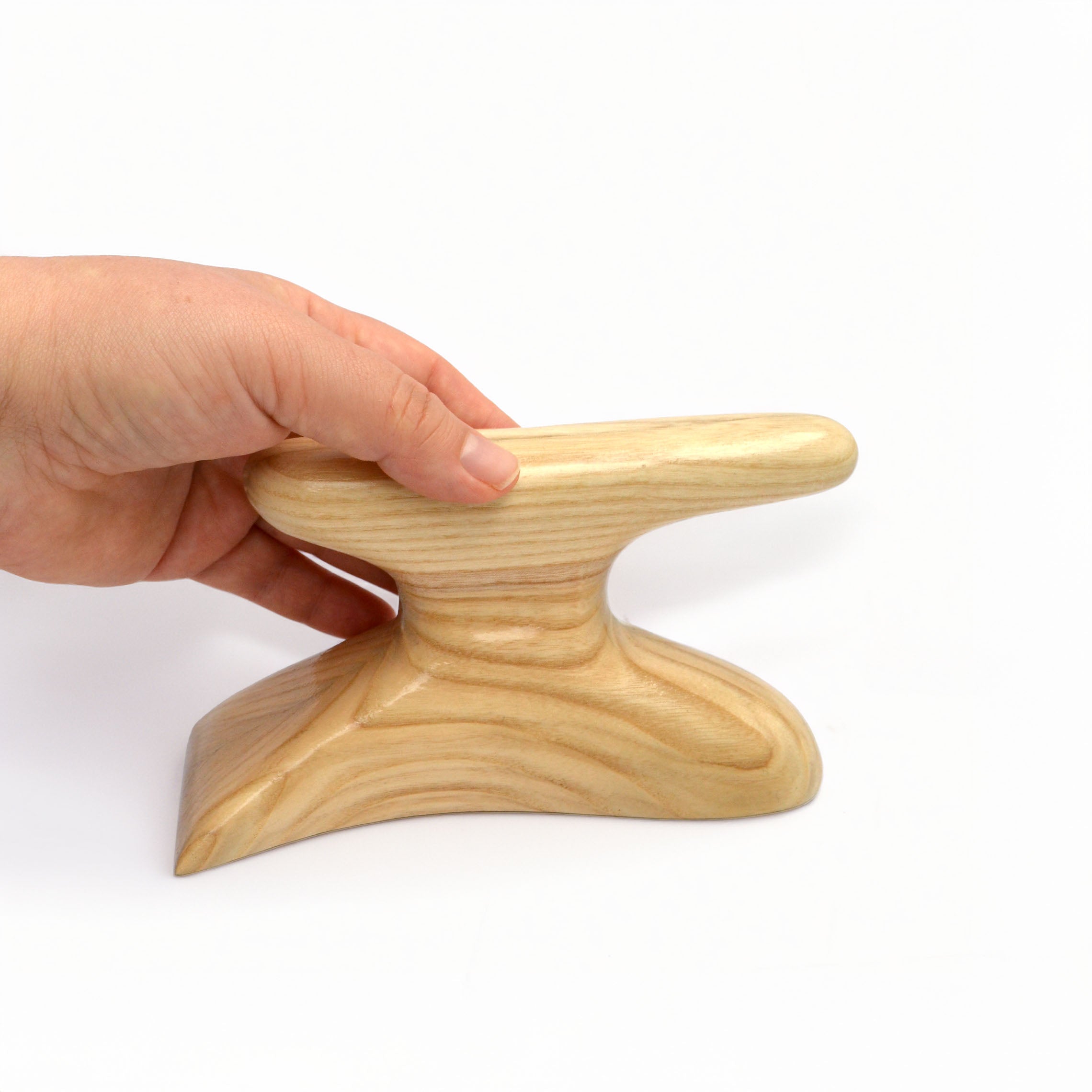 Wooden foot tolliker held in hand for shaping felt hat brims