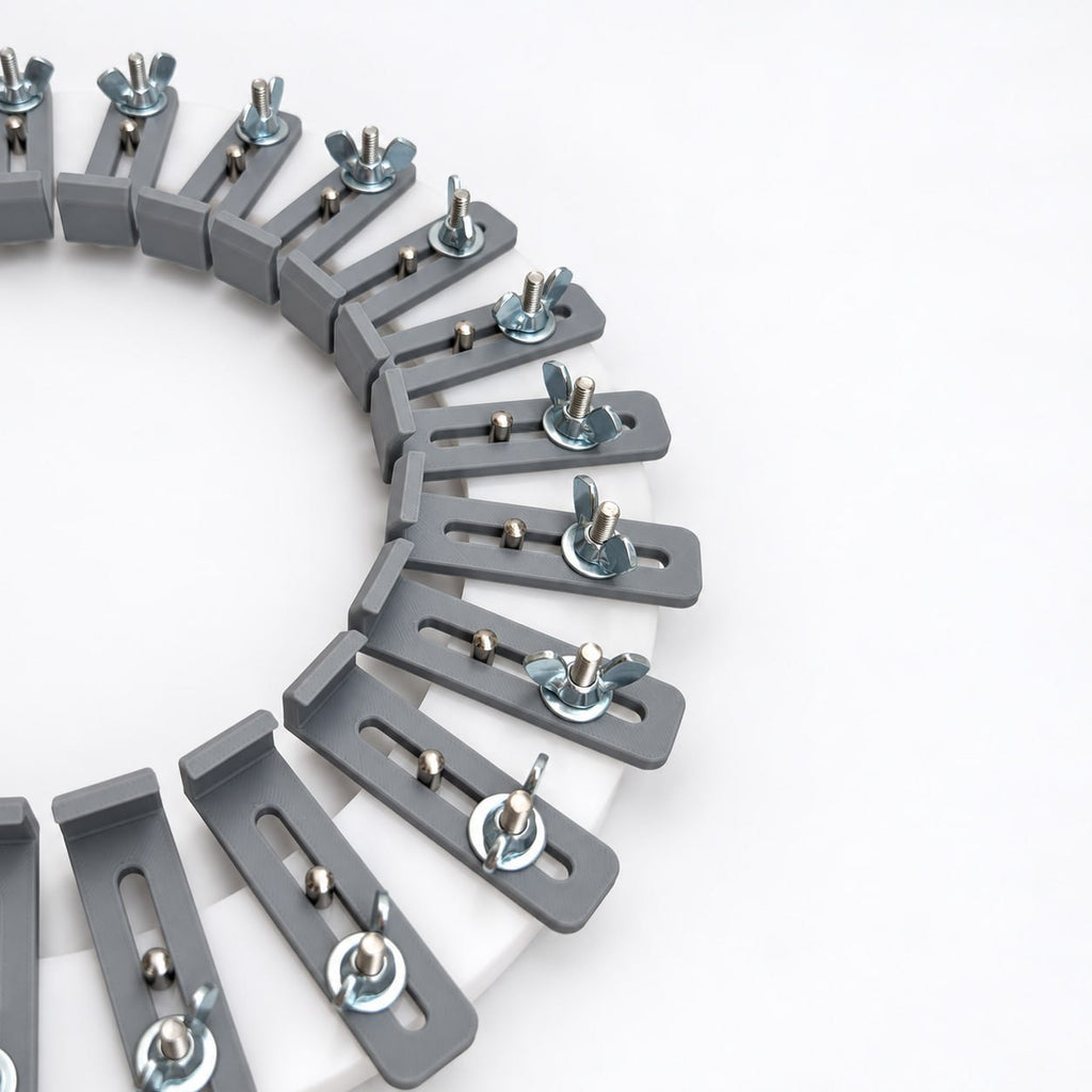 Angled close-up of gray adjustable fingers secured with metal washers and wing nuts on a white acrylic hat conformateur used to record individual head contours.