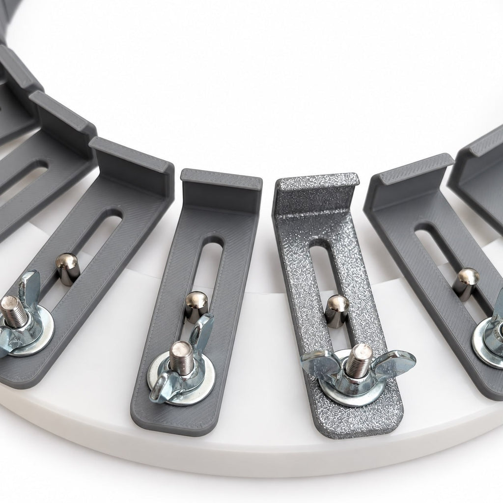 Detailed view of the 3D-printed conformateur fingers, slotted adjustment tracks, guide pins, and locking hardware mounted around the acrylic circular base.