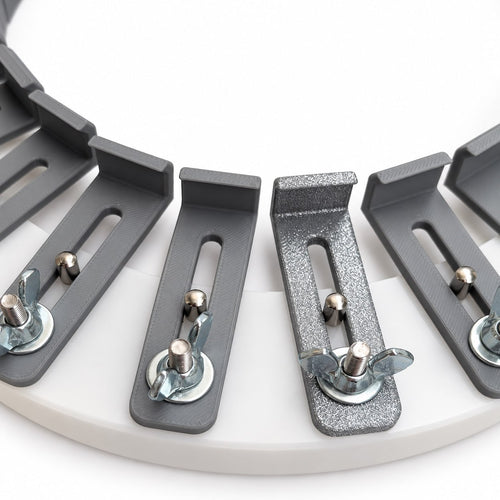 Detailed view of the 3D-printed conformateur fingers, slotted adjustment tracks, guide pins, and locking hardware mounted around the acrylic circular base.