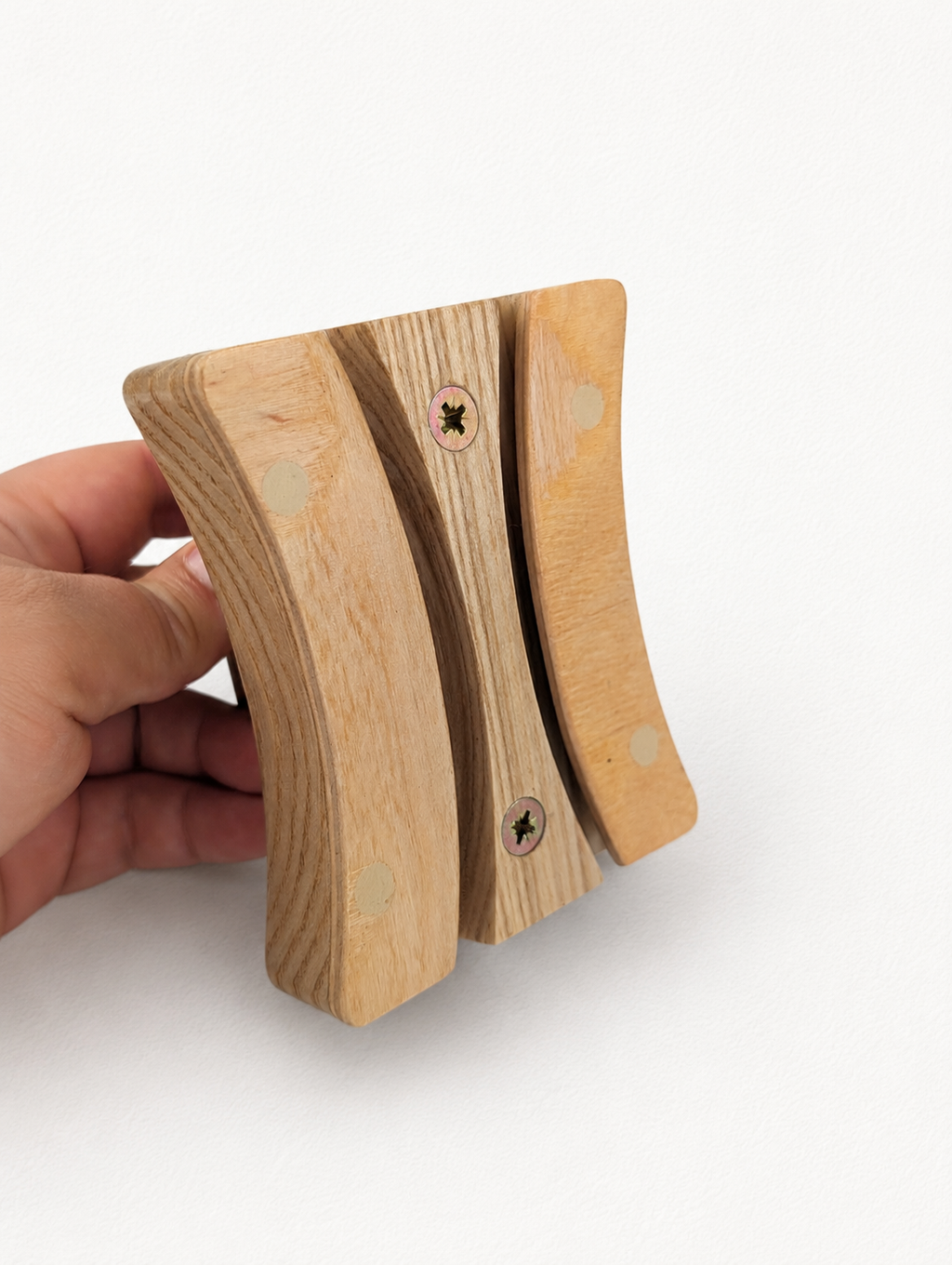 Back view of wooden double brim curler showing curved grooves and screws