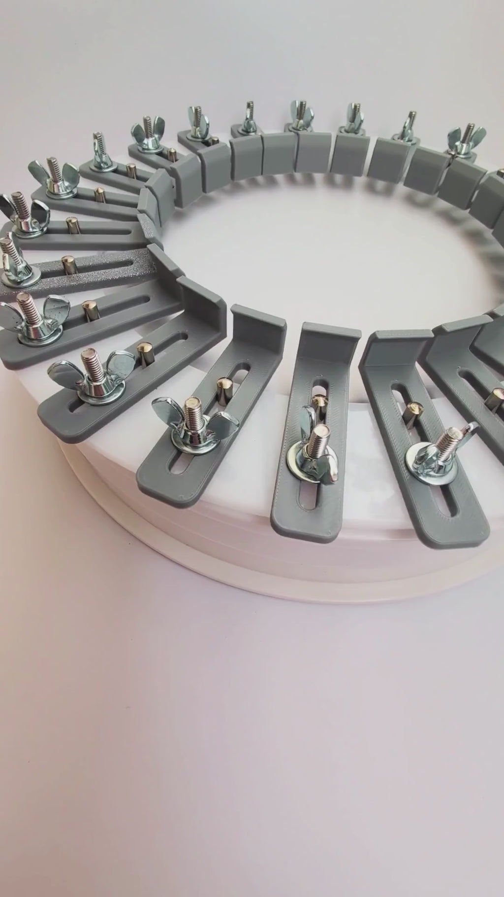 Video showing an acrylic hat conformer with individually adjustable 3D-printed fingers, stainless steel wing nuts, and guide pins used to capture a customer’s head shape for custom hat fitting.