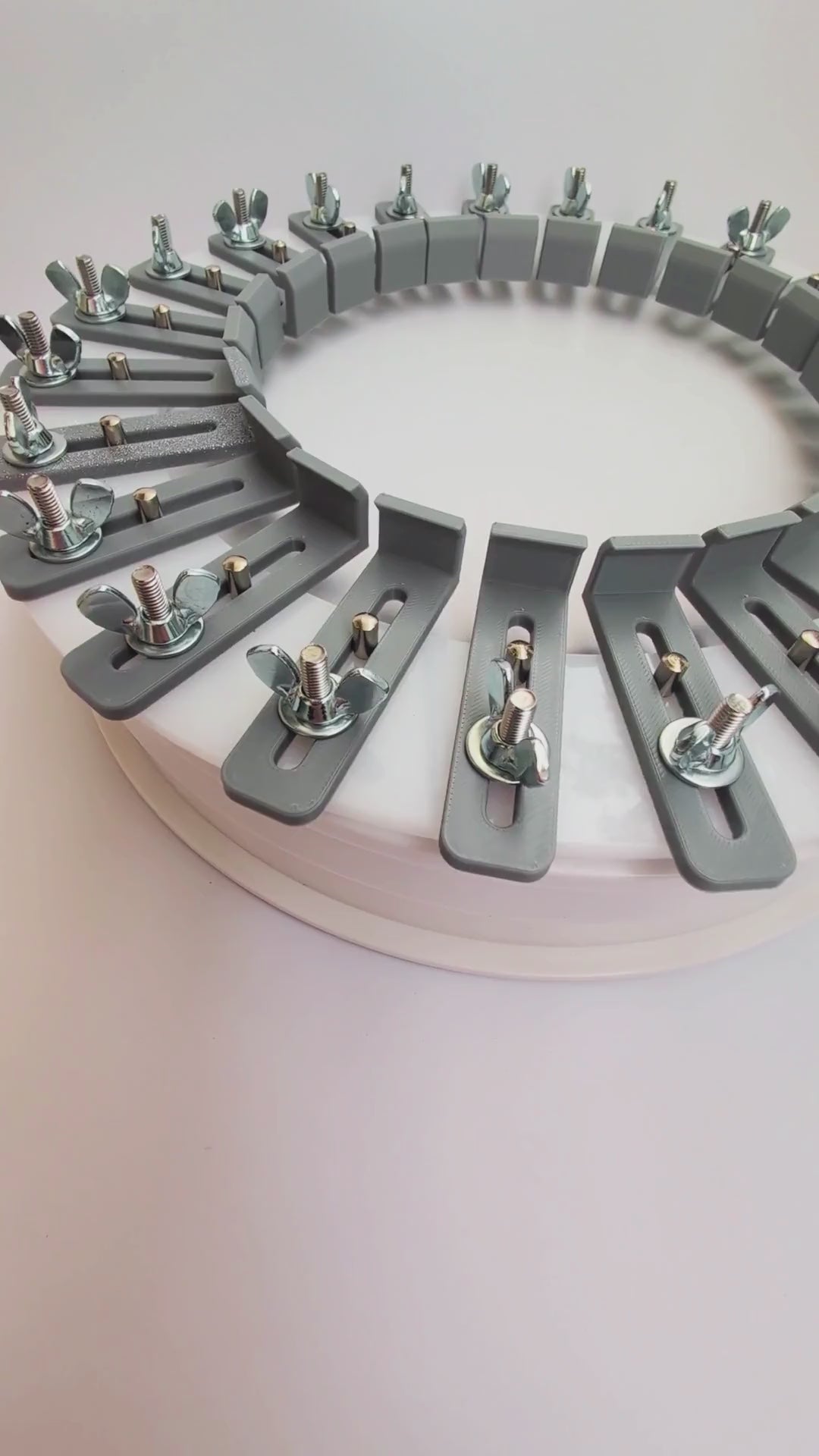 Video showing an acrylic hat conformer with individually adjustable 3D-printed fingers, stainless steel wing nuts, and guide pins used to capture a customer’s head shape for custom hat fitting.